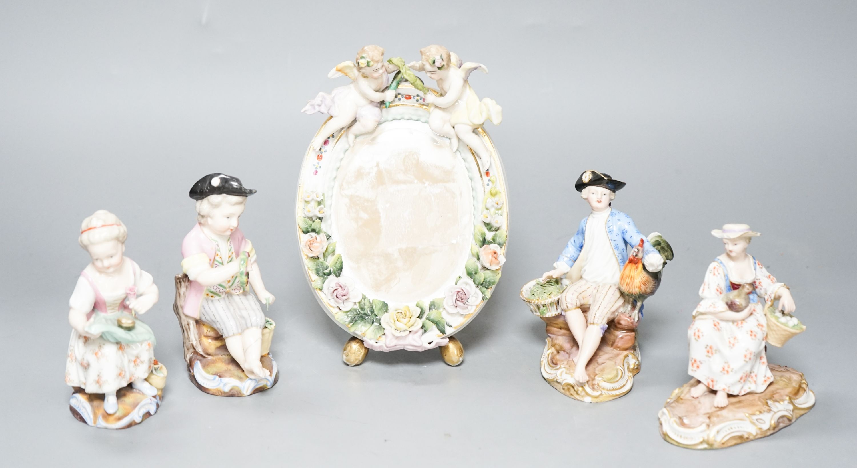 A pair of Meissen groups holding chickens, 10.5cm, a pair of Sitzendorph figures and a Sitzendorf mirror 18cm